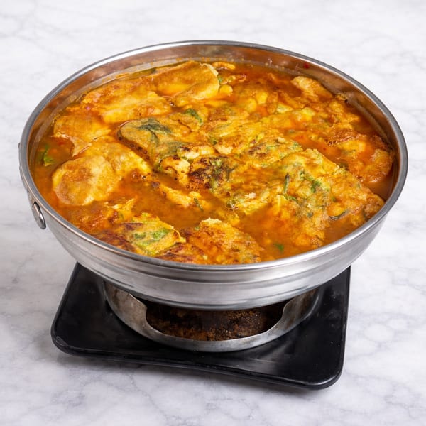 Sour curry soup with acacia omelette in a hot pot.