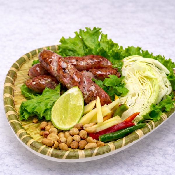 Grilled Thai sausage with cabbage, lime, peanuts, and chilies.